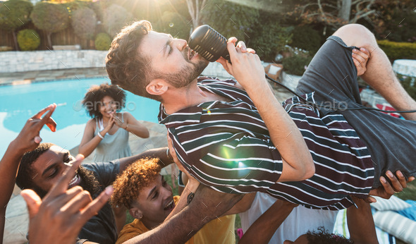 Microphone, singing and crowd surfing with a man performer at a party outdoor during summer. Concer