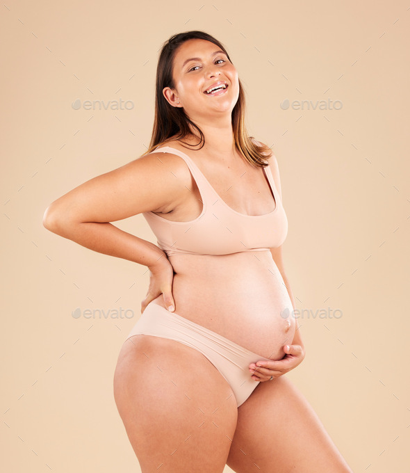 Laughing, body or holding pregnancy stomach in underwear on studio  background protection, woman lov Stock Photo by YuriArcursPeopleimages