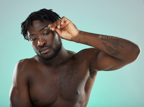 Black man, studio and tweezer for eyebrows, cosmetic beauty and grooming by blue background for wel - Stock Photo - Images