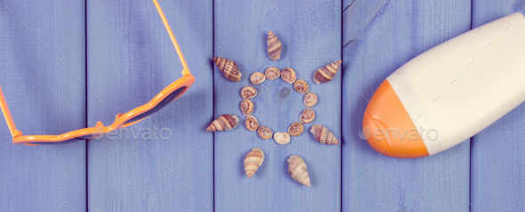 Seashells in shape of sun and accessories for summer or vacation - Stock Photo - Images