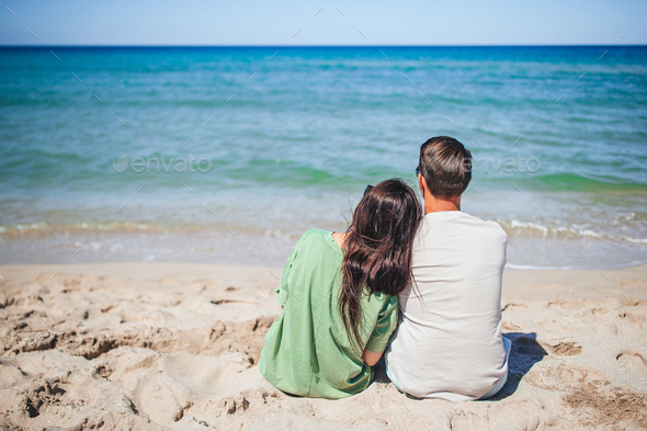Young couple on white beach during summer vacation - Stock Photo - Images