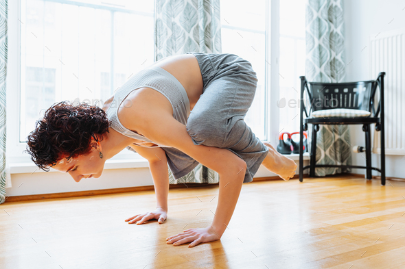 Front view of cute girl practicing yoga, standing in crane exercise Stock  Photo by sofiiashunkina