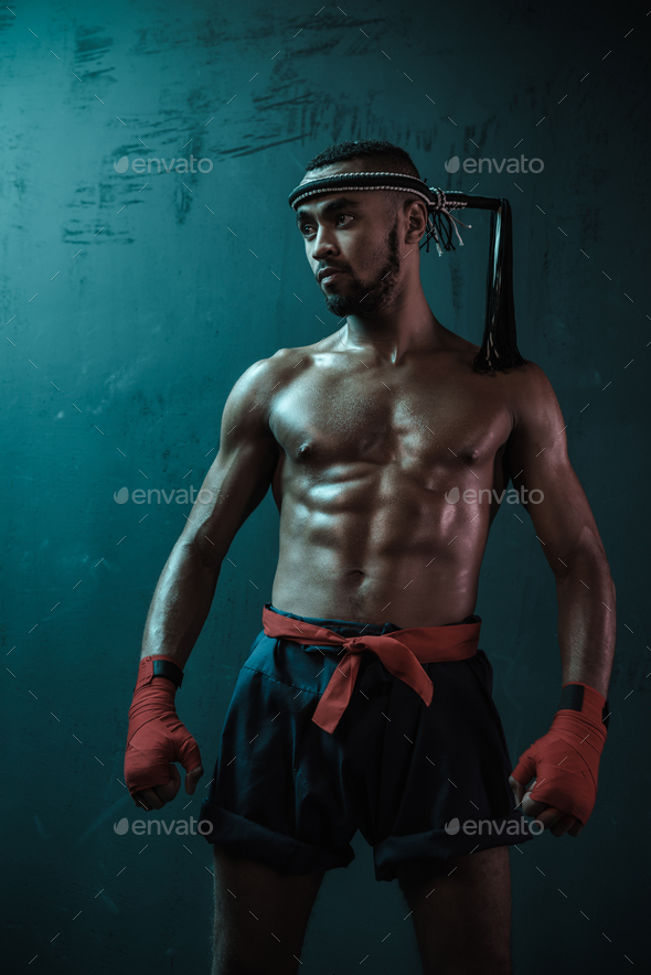 Muay Thai athlete training at Thai boxing indoors, ultimate fight concept