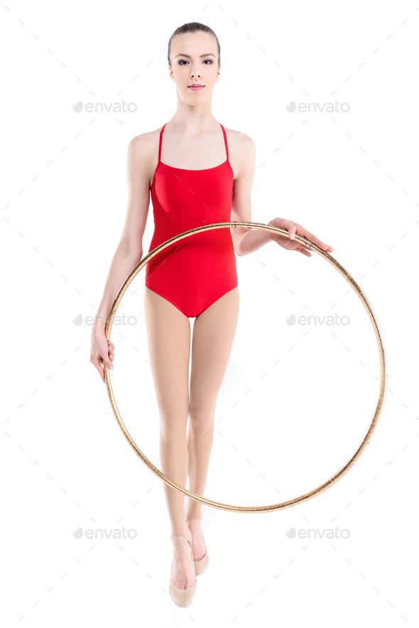 Rhythmic gymnastics. Gymnast girl performs an exercise with hoop