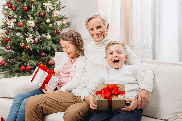 grandfather and adorable little kids with christmas gifts at home - Stock Photo - Images