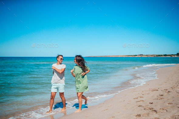 Young couple on white beach during summer vacation. - Stock Photo - Images