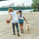 young couple on walk with dog on beach - PhotoDune Item for Sale