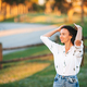 Portrait of happy young woman outdoor in the park at sunset - PhotoDune Item for Sale