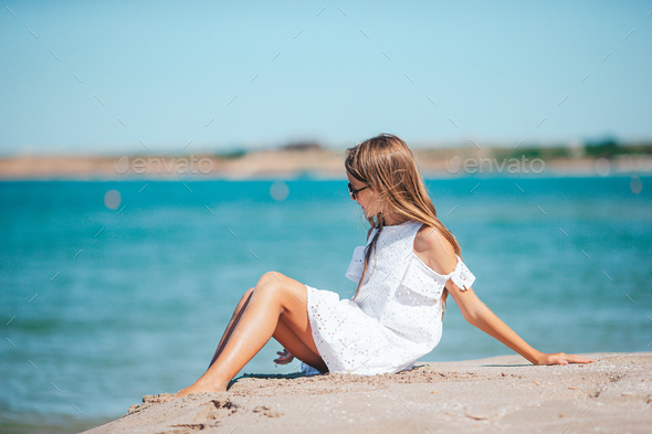 Beautiful teen girl on the beach during summer vacation  - Stock Photo - Images