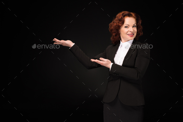 Half-length shot of businesswoman in a suit outstretching her arms as pretending to hold something