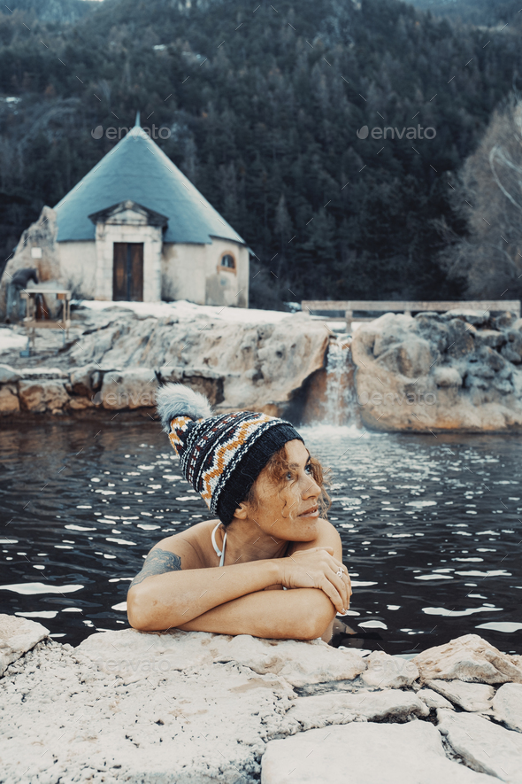 Wellness tourism vacation. Female people enjoying warm thermal natural pool water in winter