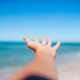 Closeup hand on background of the sea and sky - PhotoDune Item for Sale