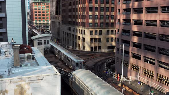 Subway Train Going Through A City Center With Tall Buildings Chicago alt