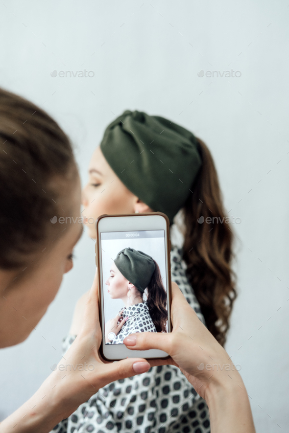 Women fashion designer taking photo to accessories with cell phone or smartphone digital camera for - Stock Photo - Images