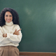 Young happy business woman teacher pointing at empty blackboard. - PhotoDune Item for Sale