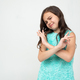 offended teenage girl in a blue dress doubts on a white studio background - PhotoDune Item for Sale