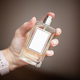 Woman hand holding bottle of perfume - PhotoDune Item for Sale