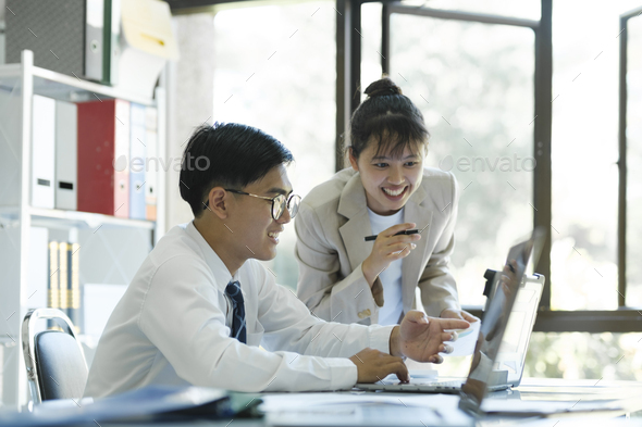 Businesspeople are working by discuss and analyses their project by using laptop and calculator. - Stock Photo - Images