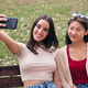 two young women smiling happy while taking a photo - PhotoDune Item for Sale
