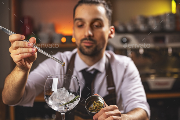 Expert barman is making cocktail - Stock Photo - Images
