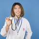 Smiley asian doctor showing the medical stethoscope - PhotoDune Item for Sale