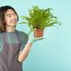 Asian man holding a fern in a pot - PhotoDune Item for Sale