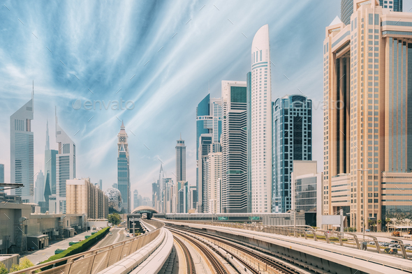 Metro road among glass skyscrapers in Dubai. Metropolitan railway among glass skyscrapers in Dubai - Stock Photo - Images