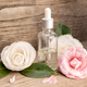 Camellia essential oil bottle and camellia flowers - PhotoDune Item for Sale