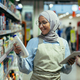 A young Arab woman in a hijab works in a supermarket, salesperson, consultant - PhotoDune Item for Sale