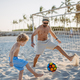 Father with his son plaing football on the beach. - PhotoDune Item for Sale