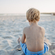 Little boy playing on the beach, rear view. - PhotoDune Item for Sale
