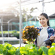 Asian female gardener in agriculture industry. Women farmer use clickboard for working and care - PhotoDune Item for Sale