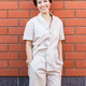 Cheerful woman in home wear pajama outdoor brick wall background emotions - sleepwear and homewear - PhotoDune Item for Sale