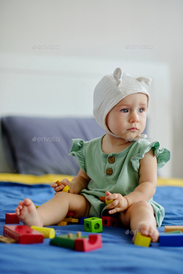 Girl Sitting on Bed with Toys - Stock Photo - Images