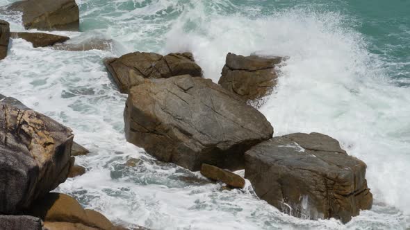Marine Water and Giant Waves Crashing at Rocky Cliff with Splashing and White Foam