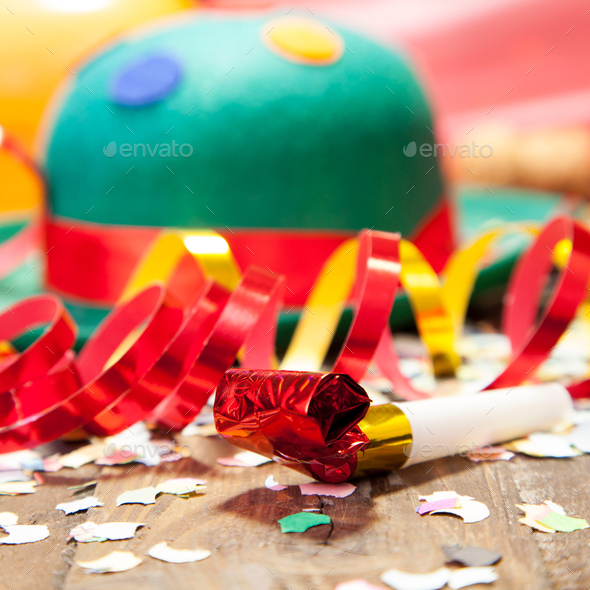 Closeup of party decorations and a green hat on the floor under the lights