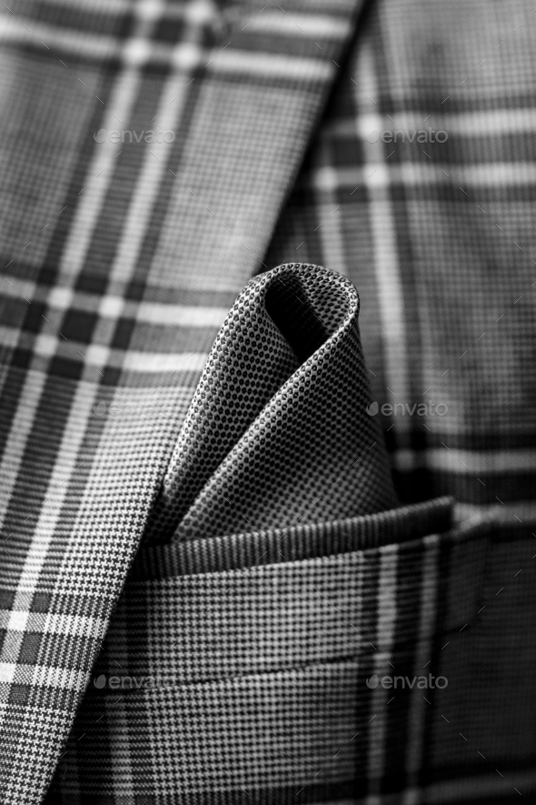 Vertical closeup shot of an elegant gray pocket square in a patterned blazer