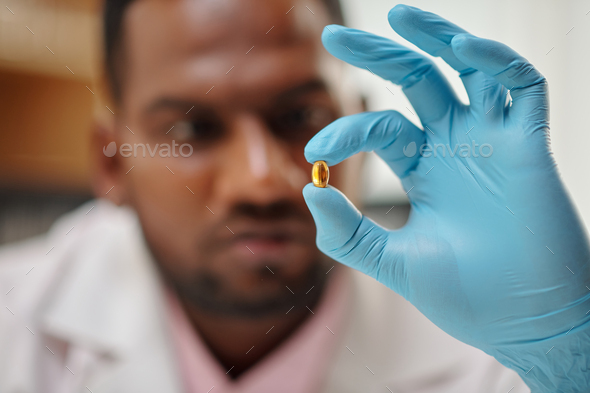 Scientist Showing fish Oil Pill - Stock Photo - Images