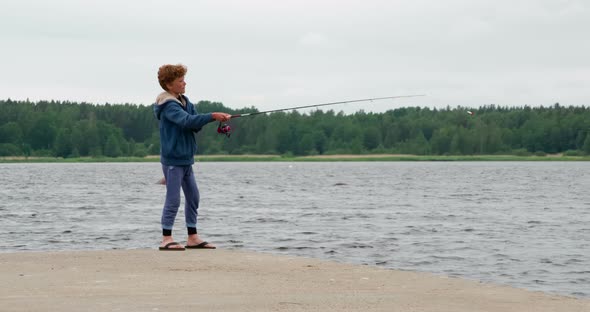 Boy Fishing On The Pier