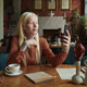 Young albino woman in casualwear talking to friend in video chat - PhotoDune Item for Sale