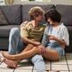 Happy young barefooted couple in casualwear relaxing on the floor - PhotoDune Item for Sale