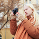 Young albino woman with photocamera taking photos of autumn city - PhotoDune Item for Sale