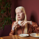 Young serene albino woman with long white hair holding cup of coffee - PhotoDune Item for Sale