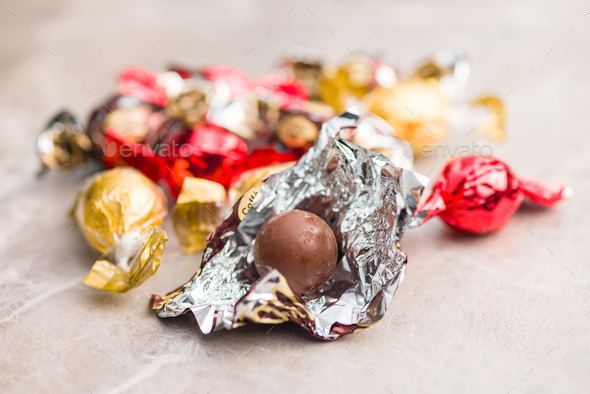 Chocolate candies in a gold wrapper, sweet chocolate candies Stock