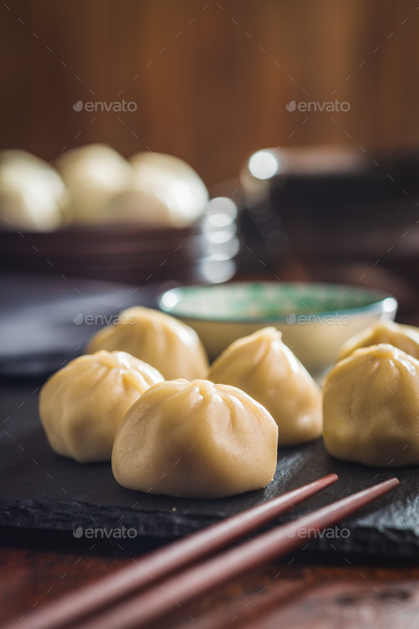 Xiaolongbao, traditional steamed dumplings. Xiao Long Bao buns on cutting board. - Stock Photo - Images