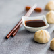 Xiaolongbao, traditional steamed dumplings and soy sauce. Xiao Long Bao buns on kitchen table. - PhotoDune Item for Sale