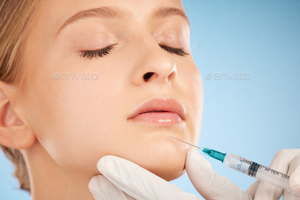 Woman, studio and botox injection for lip filler, beauty and anti-aging skincare process by blue ba