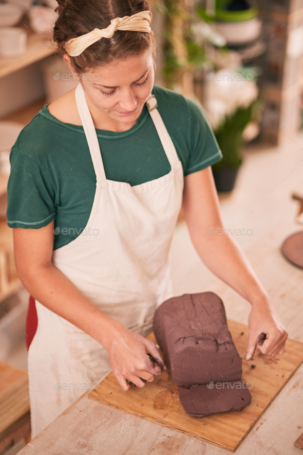 Sculptor woman, cut clay and table in workshop for artistic vision, development or pottery product.