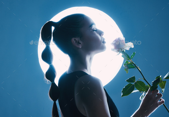 Circle light, art and woman in studio on blue background with flower for dark beauty aesthetic, mag