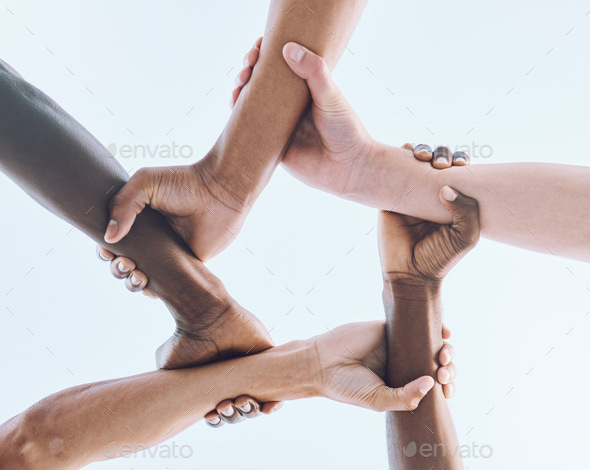 Below, hands and team, sports and collaboration, partnership and huddle against sky background. Bot - Stock Photo - Images